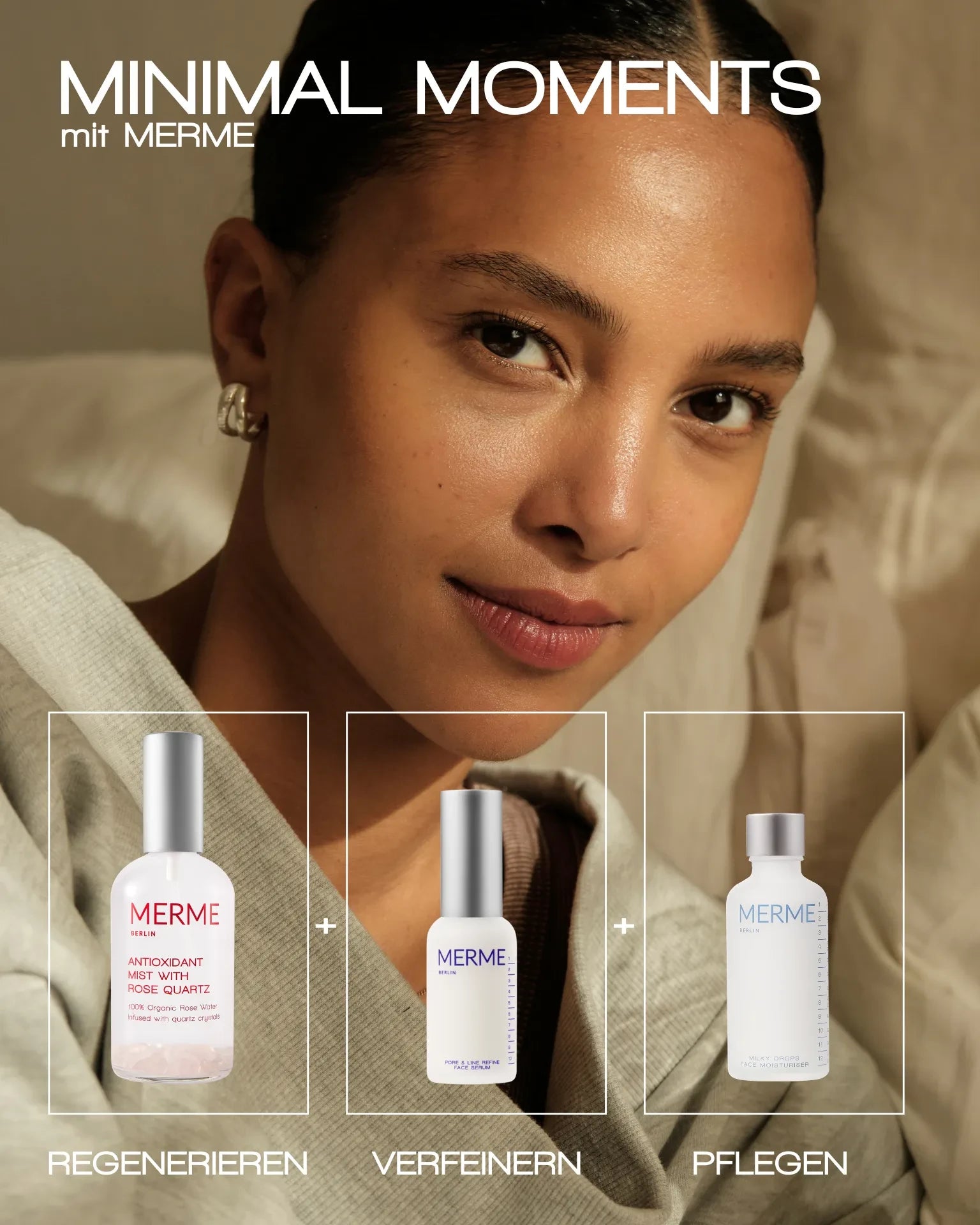 Eine Frau mit glatter Haut und einem sanften Lächeln sitzt drinnen. Vor ihr stehen drei MERME Berlin MILKY DROPS FACE MOISTURISER Produkte mit den Aufschriften „REGENERIEREN“, „VERFEINERN“ und „PFLEGEN“. Text: „MINIMAL MOMENTS mit MERME.“.